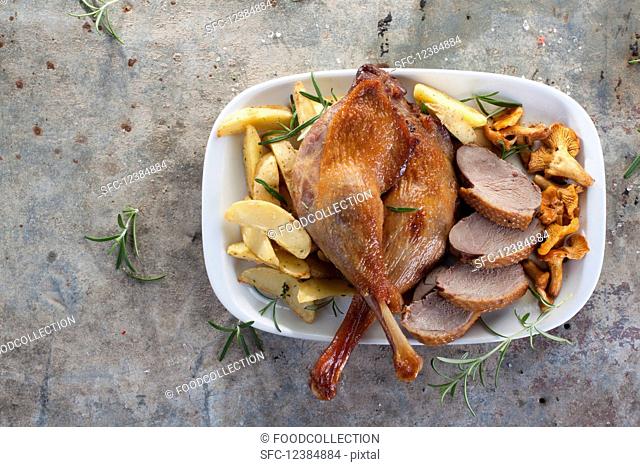 Goose legs and breast with chanterelle mushrooms and roast potatoes