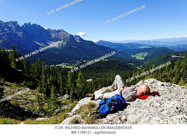 Hiker resting, Kaiserstein mountain, Rotwand mountain, Croda Rossa mountain, Rosengarten massif, UNESCO World Heritage natural site, Province of Bolzano-Bozen