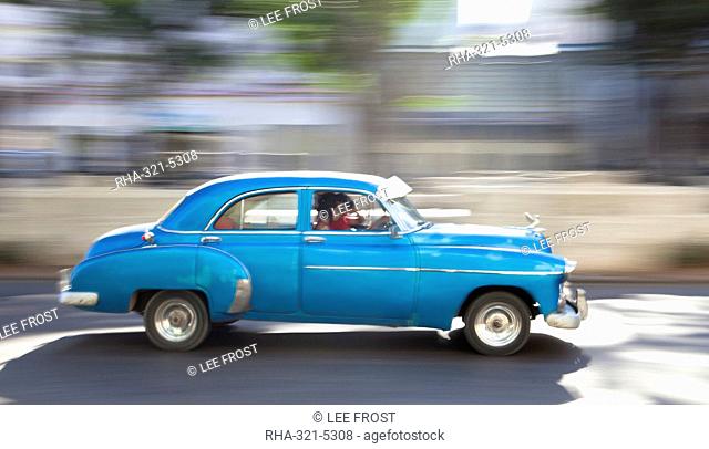 Panned' shot of old American car to capture sense of movement, Prado, Havana Centro, Cuba, West Indies, Central America