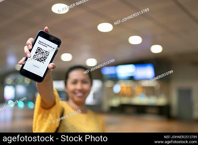 Woman holding phone with QR code