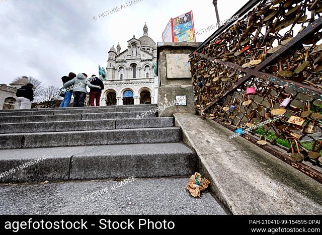 09 April 2021, France, Paris: Food packaging lies in front of the Sacre Coeur church in the Montmartre district of Paris