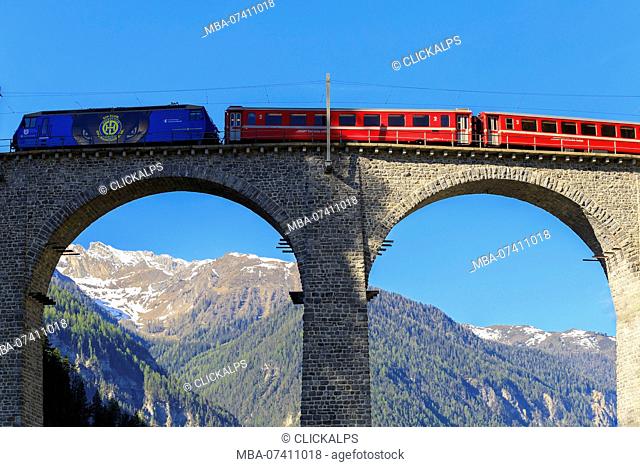 Red train transit on the Landwasser Viaduct, Filisur, Graübunden, Switzerland