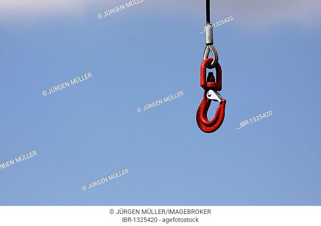 Crane hook against a blue sky