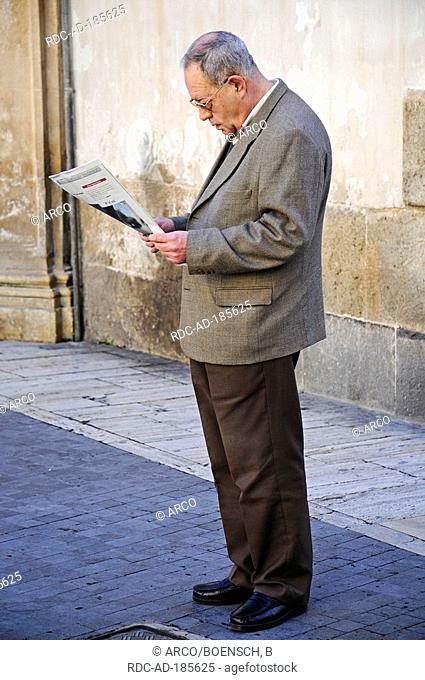 Man reading newspaper, Murcia, Spain