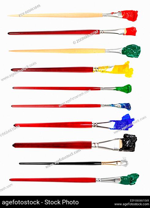 set of flat paint brushes with various colored tips in blots isolated on white background