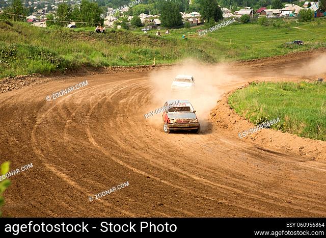Traditional rally .The racing car drives into a steep turn, scattering, spraying dirt, dust. Extreme rally, autocross