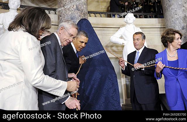 United States President Barack Obama, flanked by U.S. Senate Majority Leader Harry Reid(Democrat of Nevada), left, Speaker of the U.S
