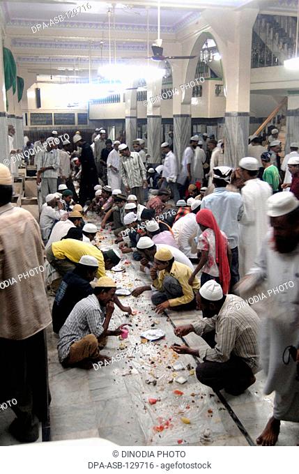 Muslims break their Ramzan or Ramadan fasting at Khatri Masjid in Pydhonie ; Bombay now Mumbai ; Maharashtra ; India