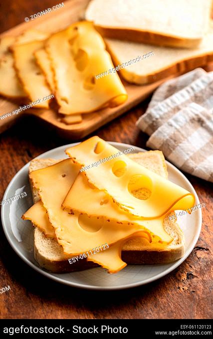 Sandwich bread with hard cheese on plate