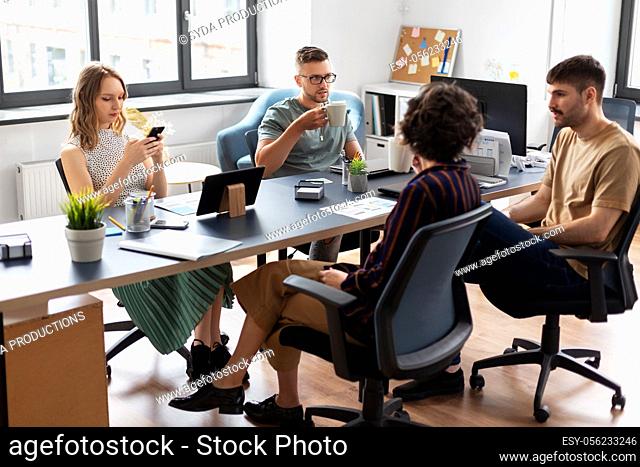 team of startuppers drinking coffee at office
