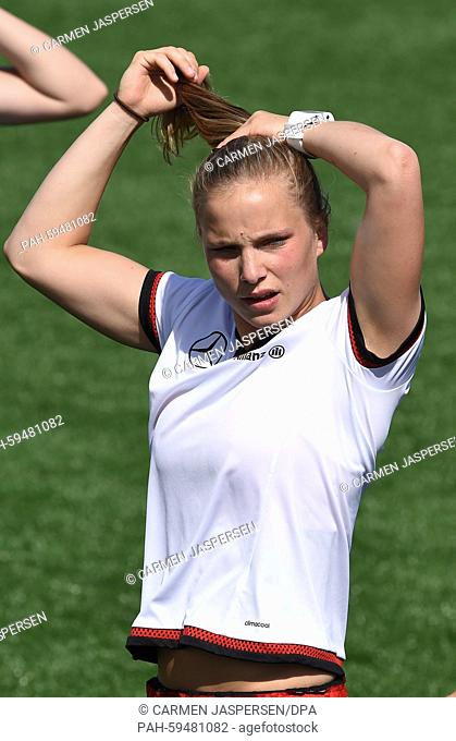 Germany's Tabea Kemme styles her hair during a training session at the FIFA Women's World Cup 2015 at the Avenue Bois-de-Boulogne, Laval in Montreal, Canada