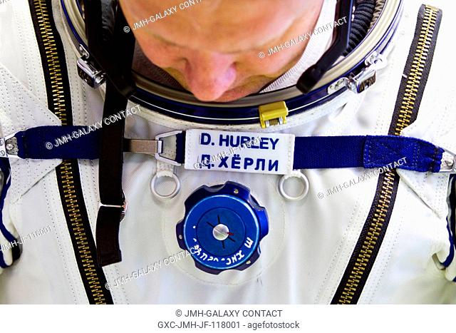 NASA astronaut Doug Hurley, STS-135 pilot, dons a Sokol spacesuit March 28, 2011, at the Zvezda facility in Moscow. Hurley's name appears first in English and...