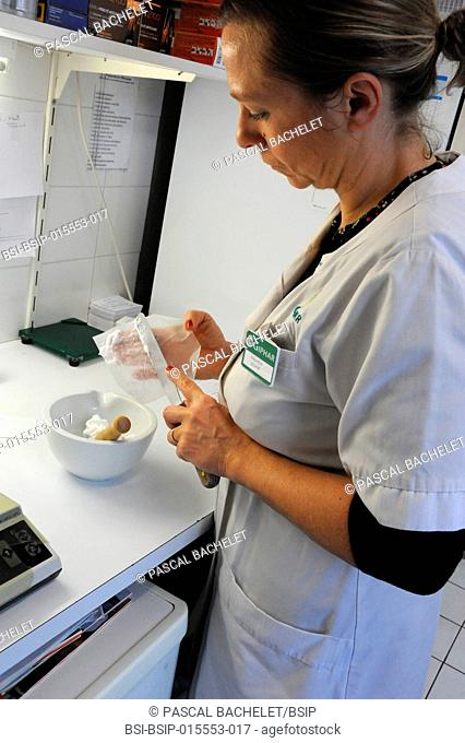 Reportage in a pharmacy in Auxi-le-Château, France. A pharmacy technician prepares a glycerol starch-based treatment