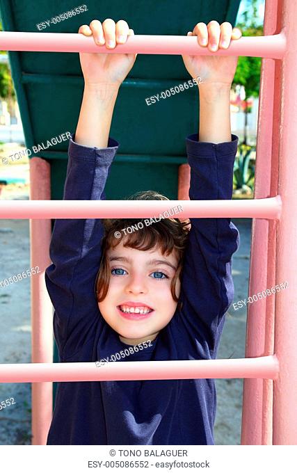 little girl climbing pink stairs of slide