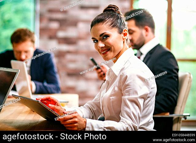 Business woman in the office with colleagues discuss business meeting. woman viewing documents. close-up shot