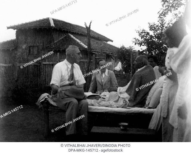 Mahatma Gandhi meeting visitors from England at Sevagram Ashram , 1940 , Pyarelal Nayar , Sushila Nayar both half covered NO MR