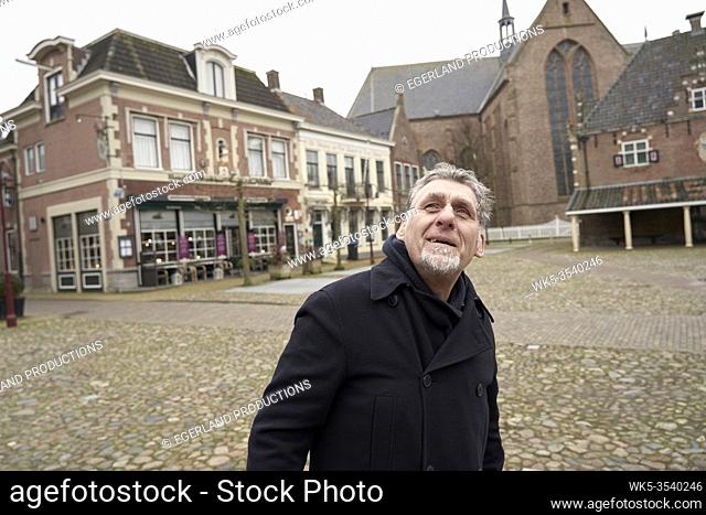 curious senior man peering up in Workum, Friesland, Netherlands