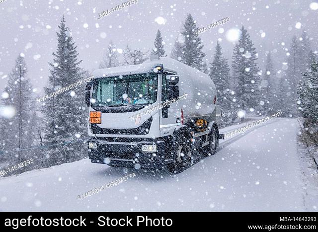 LPG tanker truck on a mountain road during a snowfall