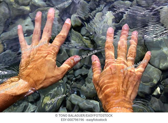 hands underwater river water wavy distorted shapes