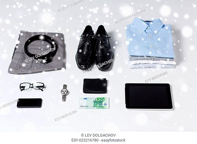 business, style, clothes and objects concept - close up of formal male clothes and personal stuff on table at home over snow effect over snow effect
