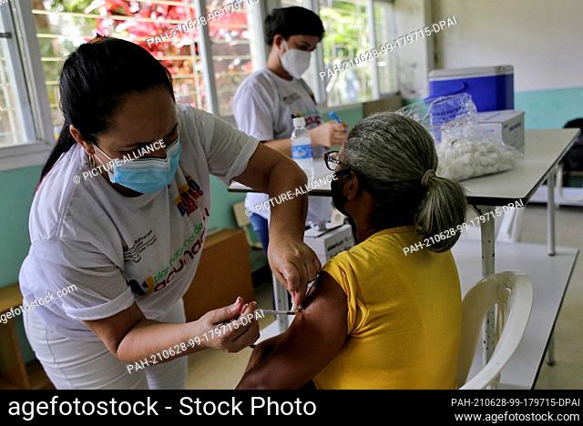 28 June 2021, Venezuela, Caracas: A health worker administers a dose of the Corona vaccine Abdala to an elderly woman. This first shipment of vaccine from Cuba...