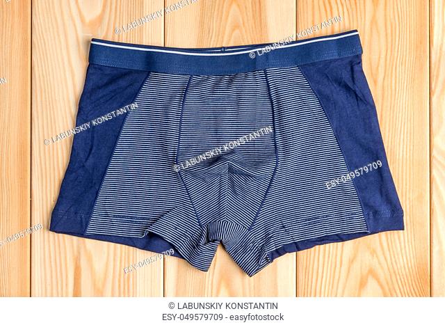 blue new cotton panties for boy clothes on wooden boards top view