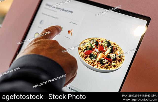 PRODUCTION - 20 July 2023, Schleswig-Holstein, Grömitz: A touch screen displays the individually configurable dishes. The cooking robot can then prepare five...