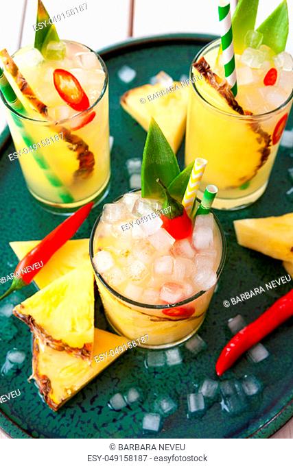 Colorful spicy cocktail with fresh pineapple and chili peppers