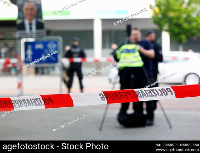 05 May 2022, North Rhine-Westphalia, Duisburg: Police officers examine the scene on the market square with a camera. Four people were injured in open-street...