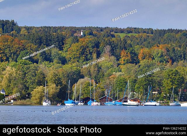 District Starnberg, Germany October 04, 2020: Impressions Starnberger See - 2020 View from Hoehenrieder Park to Unterzeismering and above the Nikolauskircherl...