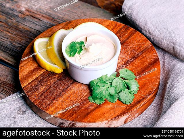 Delicious hummus on the wooden table