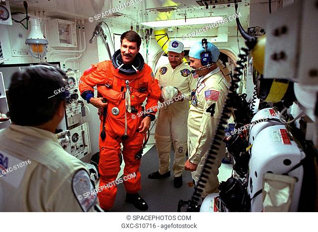 08/07/1997 --- STS-85 Pilot Kent V. Rominger visits with white room closeout crew members Mike Mangione left foreground, Jack Burritt center