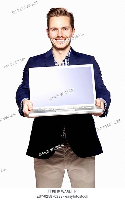 Photo of happy businessman giving his laptop with copy space