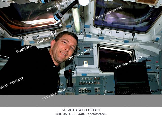 Astronaut Rick D. Husband, STS-107 mission commander, is pictured on the aft flight deck of the Earth-orbiting Space Shuttle Columbia