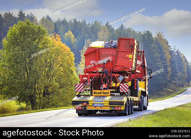 MAN truck of Mateo Transport hauls Grimme SE 75-30 potato harvester on road on a beautiful day of autumn, rear view. Salo, Finland. Sept 25, 20