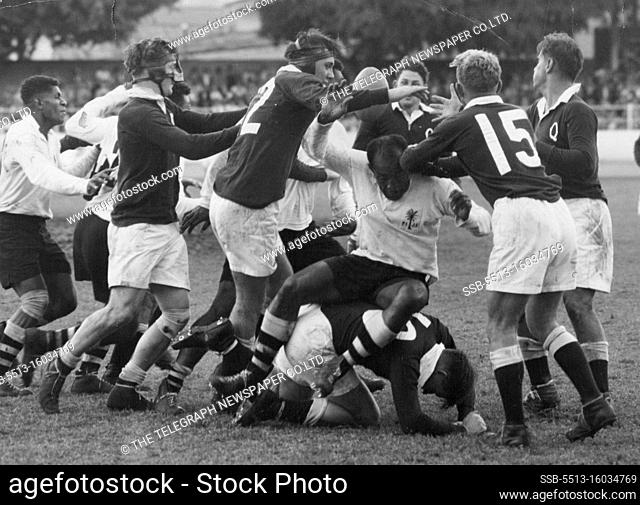 Fijian Captain Tuitava sip on Queensland forward O'Brien in a saaammage for the ball. May 29, 1954. (Photo by The Telegraph Newspaper Co.Ltd.)