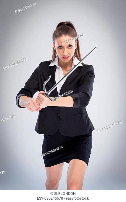 Beautiful woman in serious mood with a m training sword