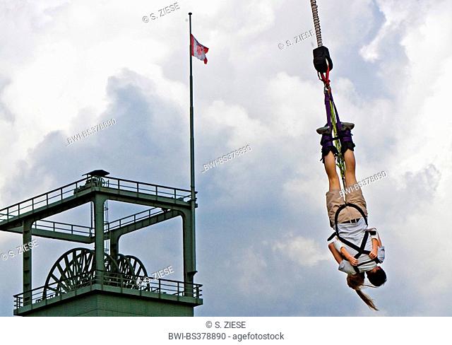bungee jumping in front of a pit frame in Olga Park, Germany, North Rhine-Westphalia, Ruhr Area, Oberhausen