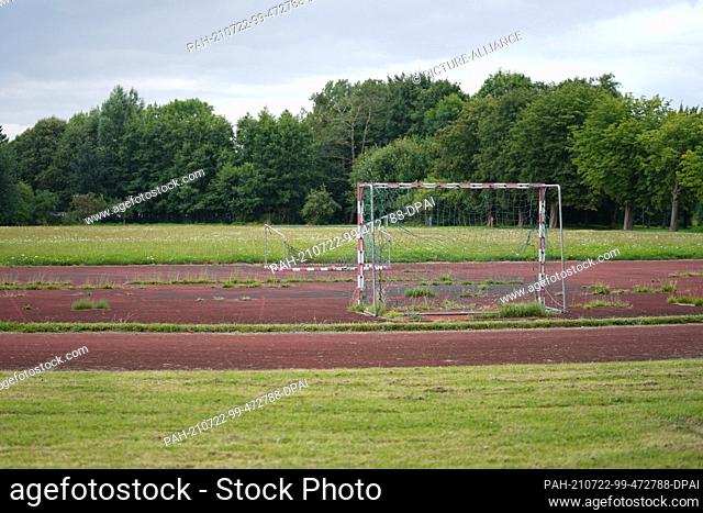 20 July 2021, Schleswig-Holstein, Gücksstadt: Football goals stand and lie on the deed track on a neglected sports field on the former site of a barracks