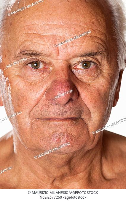 Face of an old man with tanned skin