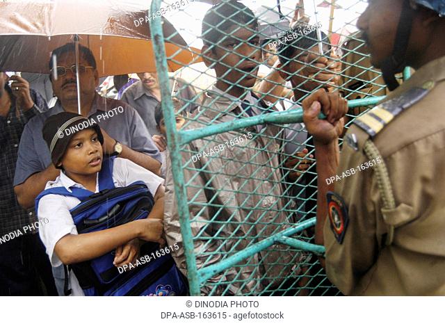 School children with parents holding umbrellas protesting against corruption at New Bombay Navi Mumbai ; Maharashtra ; India NO MR