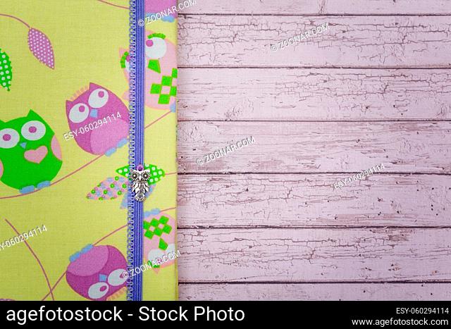 Beautiful handmade travel paper folder with owl design lying on purple wooden background. Scrapbooking. Copy space