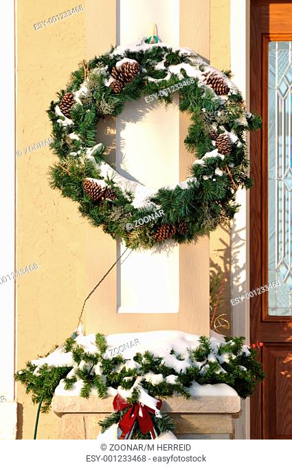 Christmas Wreath and Other Decorations Covered with Snow
