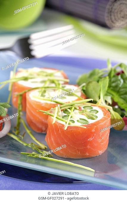 Smoked salmon rolls with cheese cream and asparagus