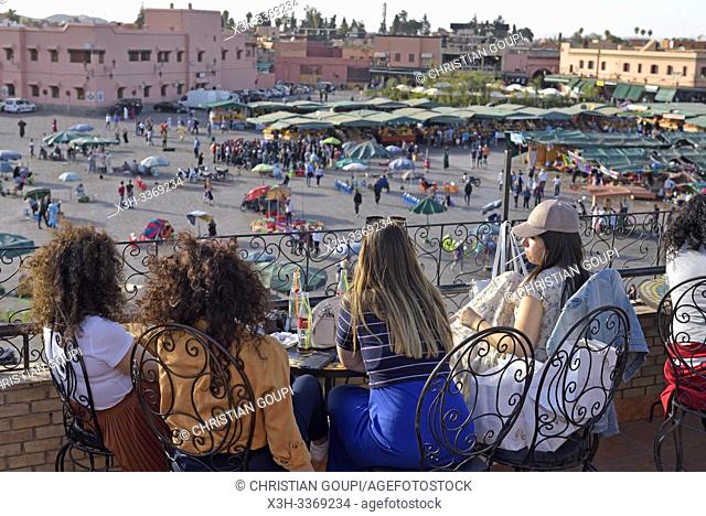 young women sitting on the terrace of the Argana cafe on Jemaa el-Fnaa square, proclaimed Masterpiece of the Oral and Intangible Heritage of Humanity Medina of...