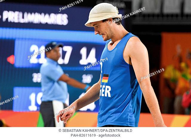 Lars Fluggen of Germany reacts during the Men's Preliminary Pool B match Brouwer/Meeuwsen of the Netherlands against Bockermann/Fluggen of Germany at the Beach...