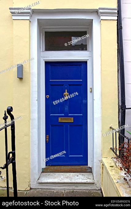 Blue Door Entrance With Brass Knocker
