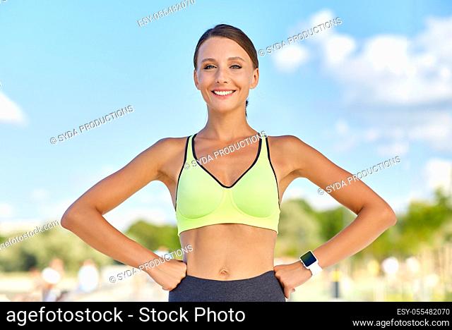 portrait of smiling young sporty woman outdoors