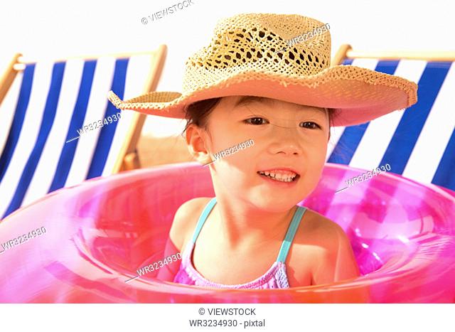 The little girl wearing a sun hat