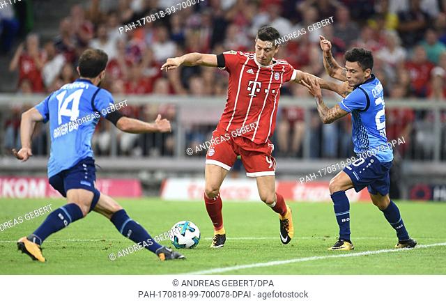 Muenchen's Robert Lewandowski (C) and Leverkusen's Admir Mehmedi (L) and Charles Mariano Aranguiz (R) vie for the ball during the German Bundesliga soccer match...